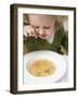 Small Girl Eating Soup with Teddy Bear Pasta-null-Framed Photographic Print