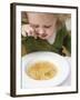 Small Girl Eating Soup with Teddy Bear Pasta-null-Framed Photographic Print