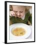 Small Girl Eating Soup with Teddy Bear Pasta-null-Framed Photographic Print