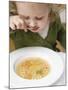 Small Girl Eating Soup with Teddy Bear Pasta-null-Mounted Photographic Print