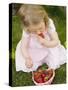 Small Girl Eating Strawberries on Grass-null-Stretched Canvas