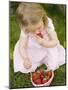 Small Girl Eating Strawberries on Grass-null-Mounted Photographic Print