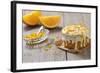 Small Orange Cake with White Icing on Wooden Table-Jana Ihle-Framed Photographic Print