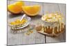 Small Orange Cake with White Icing on Wooden Table-Jana Ihle-Mounted Photographic Print