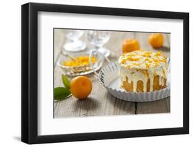 Small Orange Cake with White Icing on Wooden Table-Jana Ihle-Framed Photographic Print