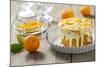 Small Orange Cake with White Icing on Wooden Table-Jana Ihle-Mounted Photographic Print