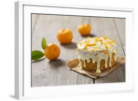 Small Orange Cake with White Icing on Wooden Table-Jana Ihle-Framed Photographic Print