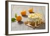 Small Orange Cake with White Icing on Wooden Table-Jana Ihle-Framed Photographic Print