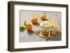 Small Orange Cake with White Icing on Wooden Table-Jana Ihle-Framed Photographic Print