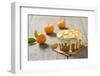 Small Orange Cake with White Icing on Wooden Table-Jana Ihle-Framed Photographic Print