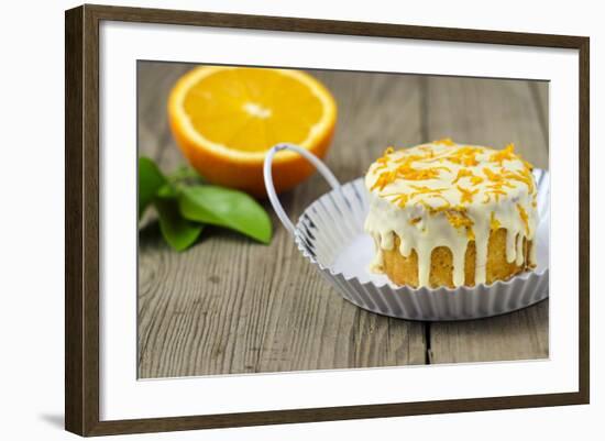 Small Orange Cake with White Icing on Wooden Table-Jana Ihle-Framed Photographic Print