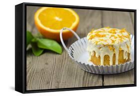 Small Orange Cake with White Icing on Wooden Table-Jana Ihle-Framed Stretched Canvas