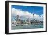 Small sailboats cruise in Auckland harbour in front of the city skyline, Auckland, New Zealand-Logan Brown-Framed Photographic Print