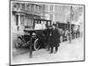 Smart Edwardian Gentleman in a Topcoat and Bowler Hat Rests a Heavy Parcel-null-Mounted Art Print