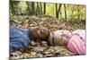Smiling Children Lying on Autumn Leaves-Ian Boddy-Mounted Premium Photographic Print