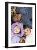 Smiling Children Lying on Autumn Leaves-Ian Boddy-Framed Photographic Print