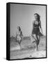 Smiling Girls Carrying Skis Out of the Water onto Beach-null-Framed Stretched Canvas