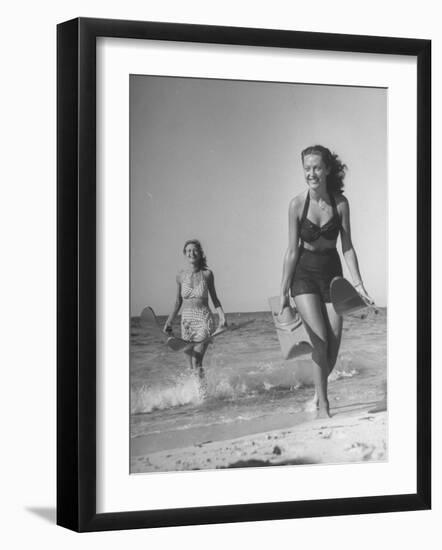 Smiling Girls Carrying Skis Out of the Water onto Beach-null-Framed Photographic Print