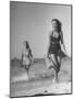 Smiling Girls Carrying Skis Out of the Water onto Beach-null-Mounted Photographic Print