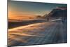 Snow Blows across an Icelandic Road at Sunrise with Mountains Looming in the Distance-Alex Saberi-Mounted Photographic Print