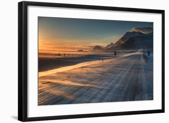 Snow Blows across an Icelandic Road at Sunrise with Mountains Looming in the Distance-Alex Saberi-Framed Photographic Print