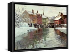 Snow-Covered Buildings by a River-Fritz Thaulow-Framed Stretched Canvas