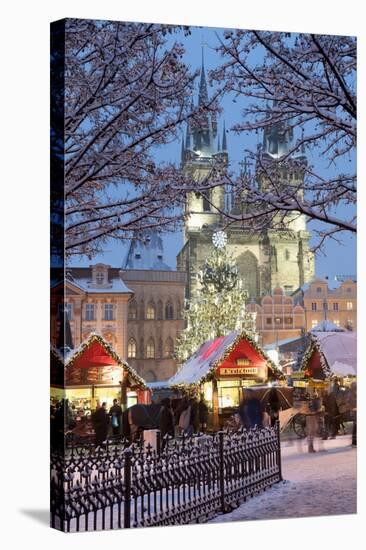 Snow-Covered Christmas Market and Tyn Church, Old Town Square, Prague, Czech Republic, Europe-Richard Nebesky-Stretched Canvas