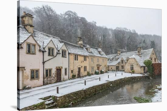 Snow covered houses by By Brook in Castle Combe, Wiltshire, England, United Kingdom, Europe-Paul Porter-Stretched Canvas