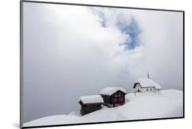 Snow Covered Mountain Huts and Church Surrounded by Low Clouds, Bettmeralp, District of Raron-Roberto Moiola-Mounted Photographic Print