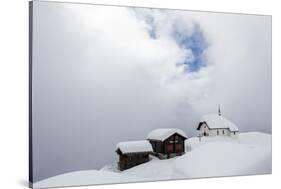 Snow Covered Mountain Huts and Church Surrounded by Low Clouds, Bettmeralp, District of Raron-Roberto Moiola-Stretched Canvas