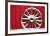 Snow-covered wagon wheels against red barn near town of Banff, Canadian Rockies, Alberta, Canada-Stuart Westmorland-Framed Photographic Print