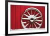 Snow-covered wagon wheels against red barn near town of Banff, Canadian Rockies, Alberta, Canada-Stuart Westmorland-Framed Photographic Print