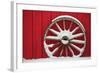 Snow-covered wagon wheels against red barn near town of Banff, Canadian Rockies, Alberta, Canada-Stuart Westmorland-Framed Photographic Print