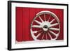 Snow-covered wagon wheels against red barn near town of Banff, Canadian Rockies, Alberta, Canada-Stuart Westmorland-Framed Photographic Print