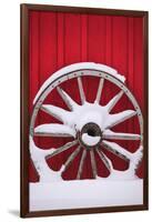 Snow-covered wagon wheels against red barn near town of Banff, Canadian Rockies, Alberta, Canada-Stuart Westmorland-Framed Photographic Print