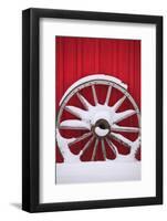 Snow-covered wagon wheels against red barn near town of Banff, Canadian Rockies, Alberta, Canada-Stuart Westmorland-Framed Photographic Print