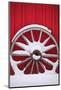 Snow-covered wagon wheels against red barn near town of Banff, Canadian Rockies, Alberta, Canada-Stuart Westmorland-Mounted Photographic Print