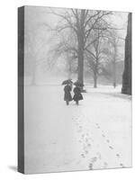 Snow Falling While People Take a Stroll Across Campus of Winchester College-Cornell Capa-Stretched Canvas