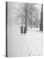 Snow Falling While People Take a Stroll Across Campus of Winchester College-Cornell Capa-Stretched Canvas