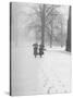 Snow Falling While People Take a Stroll Across Campus of Winchester College-Cornell Capa-Stretched Canvas