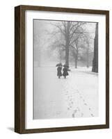 Snow Falling While People Take a Stroll Across Campus of Winchester College-Cornell Capa-Framed Photographic Print