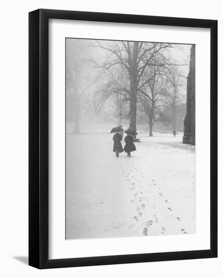 Snow Falling While People Take a Stroll Across Campus of Winchester College-Cornell Capa-Framed Photographic Print