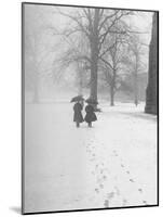 Snow Falling While People Take a Stroll Across Campus of Winchester College-Cornell Capa-Mounted Photographic Print