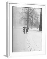 Snow Falling While People Take a Stroll Across Campus of Winchester College-Cornell Capa-Framed Photographic Print