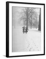 Snow Falling While People Take a Stroll Across Campus of Winchester College-Cornell Capa-Framed Photographic Print