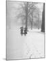 Snow Falling While People Take a Stroll Across Campus of Winchester College-Cornell Capa-Mounted Photographic Print