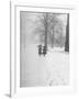 Snow Falling While People Take a Stroll Across Campus of Winchester College-Cornell Capa-Framed Photographic Print