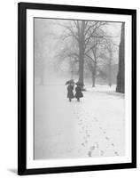 Snow Falling While People Take a Stroll Across Campus of Winchester College-Cornell Capa-Framed Photographic Print
