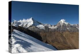 Snow on the Nyile La, a 4950m pass, and the peak of Jitchu Drake at 6714m in the distance, Bhutan,-Alex Treadway-Stretched Canvas