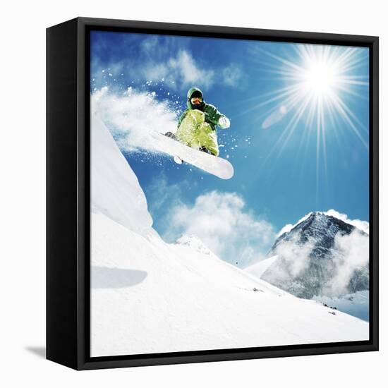 Snowboarder at Jump Inhigh Mountains at Sunny Day.-IM_photo-Framed Stretched Canvas